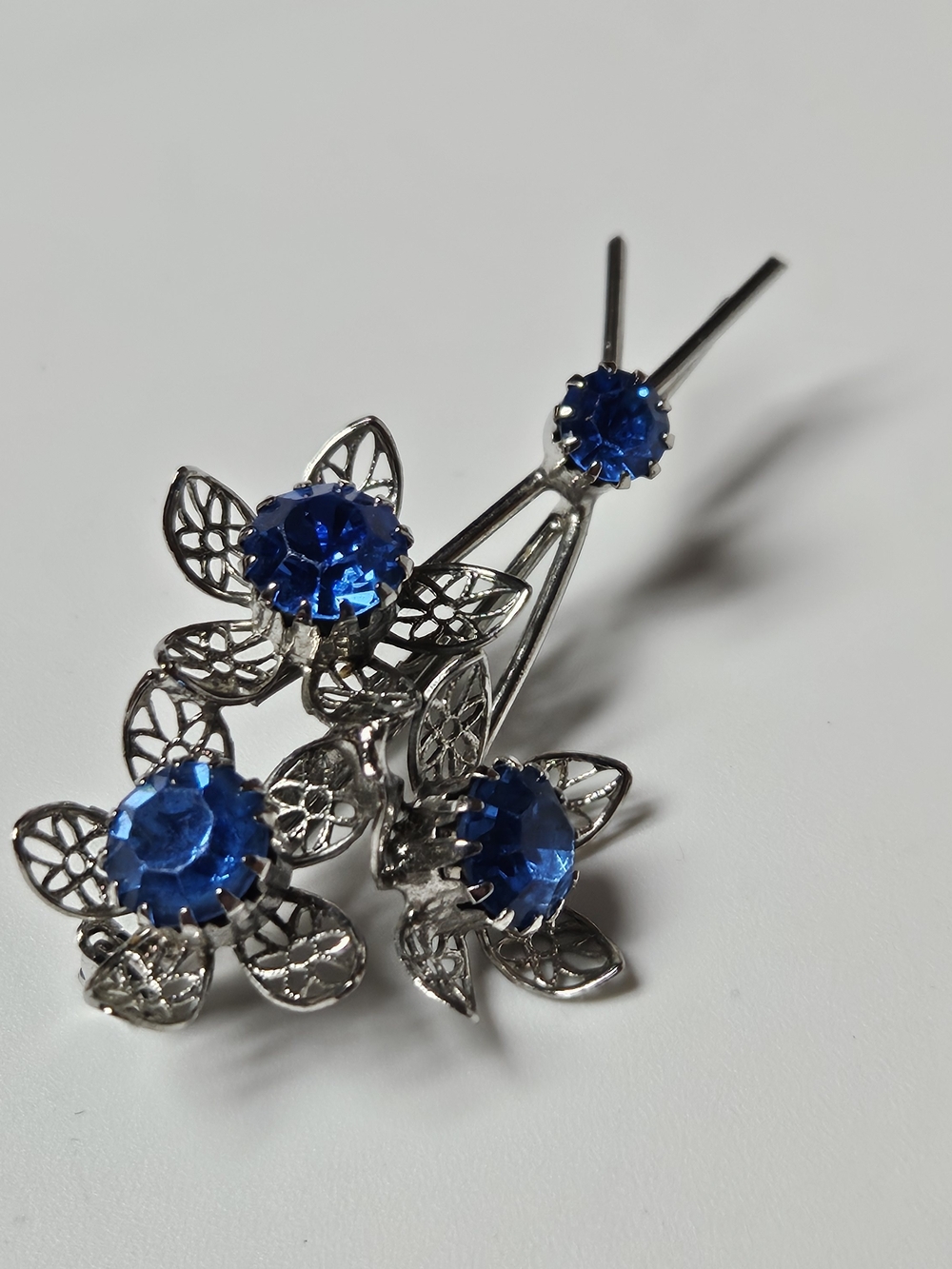 Silver Floral Brooch with Blue Crystal Accents